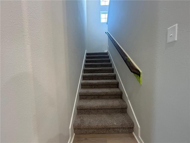 staircase featuring wood finished floors