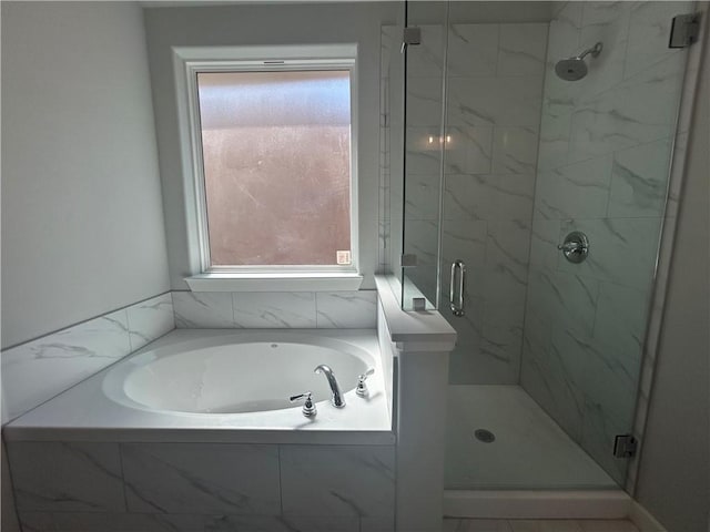 full bath with a stall shower and a bath