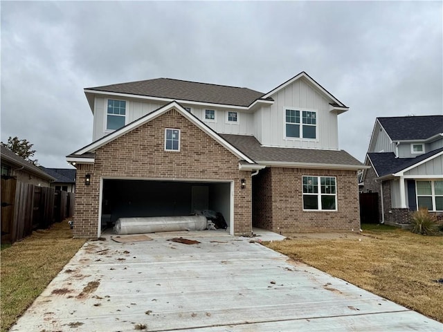 view of front of home with a garage and a front lawn