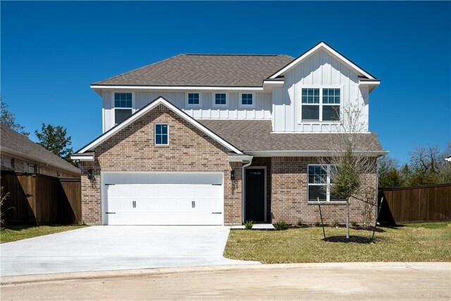 view of front of home with brick siding, board and batten siding, concrete driveway, roof with shingles, and an attached garage