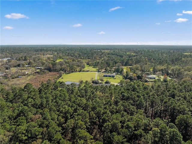 aerial view featuring a wooded view