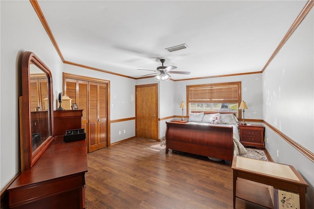 bedroom featuring ornamental molding, a closet, ceiling fan, and dark wood-type flooring