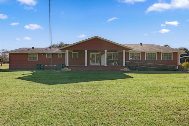 back of house with a lawn and central AC