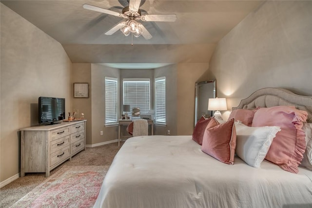 bedroom with light carpet, ceiling fan, baseboards, and vaulted ceiling