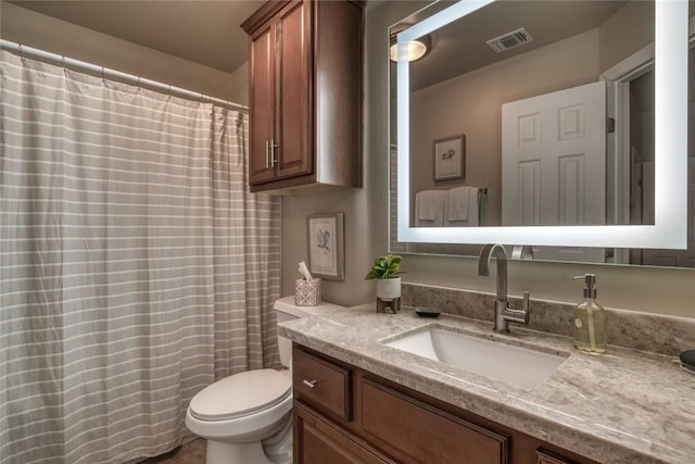 full bathroom with visible vents, vanity, and toilet