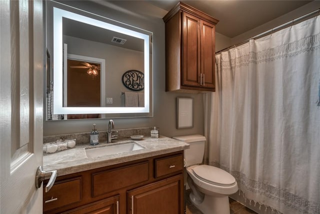 full bathroom featuring toilet, curtained shower, visible vents, and vanity