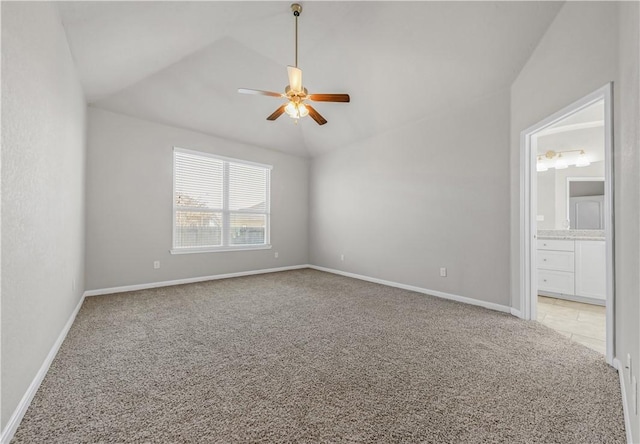 spare room featuring baseboards, light carpet, lofted ceiling, and a ceiling fan