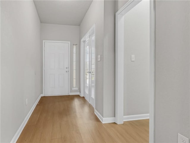 entrance foyer featuring baseboards and light wood-style flooring