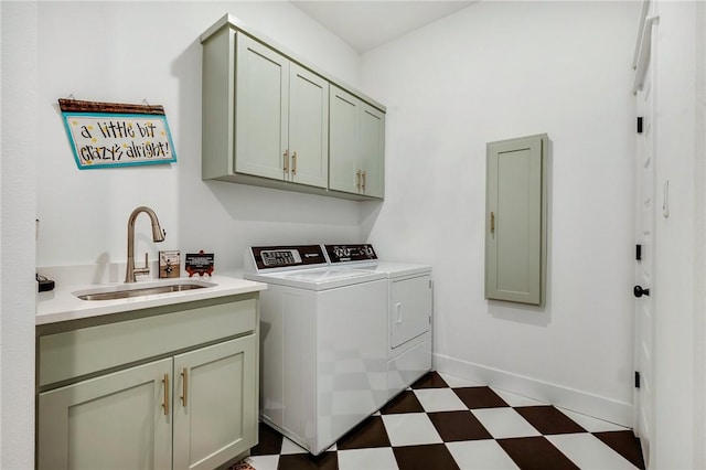 4302 Fox River Ln, Bryan, TX 77802 - laundry area with baseboards, washing machine and dryer, cabinet space, a sink, and dark floors