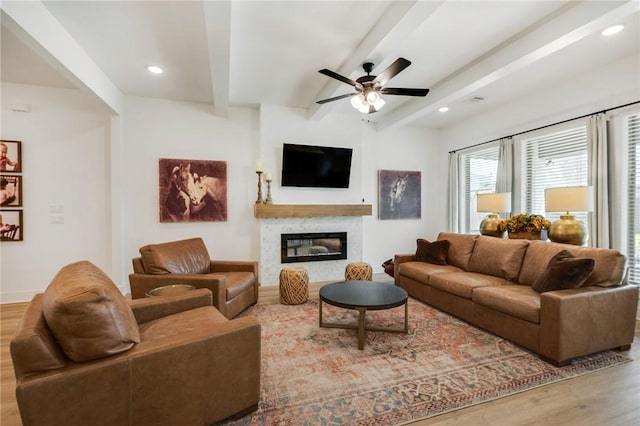 4302 Fox River Ln, Bryan, TX 77802 - living room with baseboards, a ceiling fan, a high end fireplace, beam ceiling, and wood finished floors