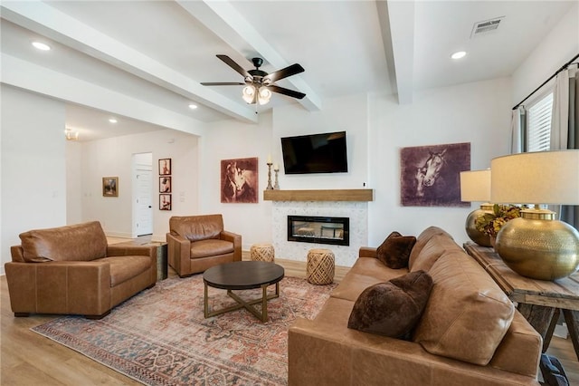 4302 Fox River Ln, Bryan, TX 77802 - living area featuring a glass covered fireplace, recessed lighting, a ceiling fan, beam ceiling, and wood finished floors