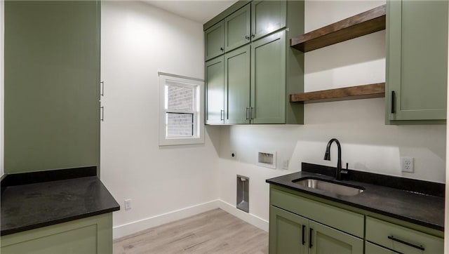 10017 Panther Creek Dr, Iola, TX 77861 - laundry room with cabinet space, hookup for an electric dryer, hookup for a washing machine, baseboards, and light wood-style floors