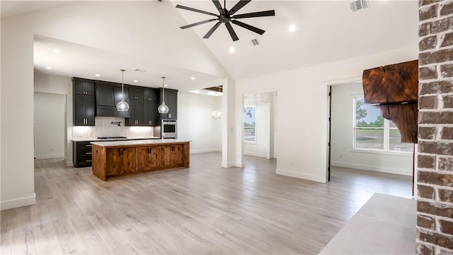 10017 Panther Creek Dr, Iola, TX 77861 - kitchen with open floor plan, extractor fan, ceiling fan, a kitchen island with sink, and light countertops
