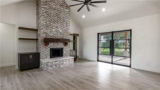 10017 Panther Creek Dr, Iola, TX 77861 - unfurnished living room with high vaulted ceiling, a ceiling fan, baseboards, light wood-type flooring, and a fireplace