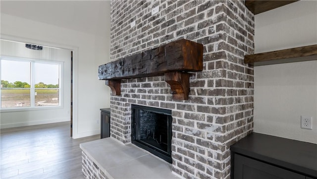 10017 Panther Creek Dr, Iola, TX 77861 - detailed view of a brick fireplace, wood finished floors, and baseboards