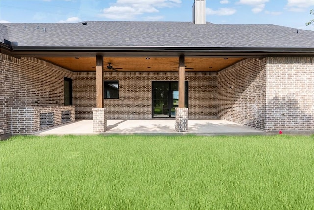 10017 Panther Creek Dr, Iola, TX 77861 - rear view of house featuring a ceiling fan, brick siding, a patio, and a lawn