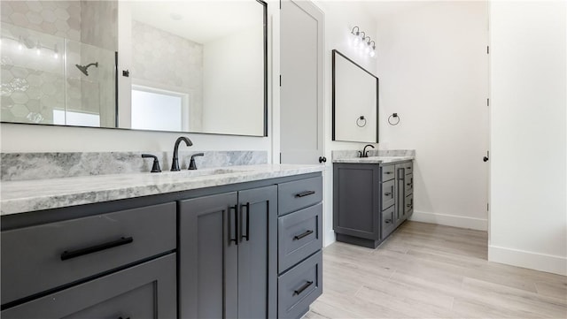 10017 Panther Creek Dr, Iola, TX 77861 - full bathroom with two vanities, a shower stall, baseboards, and wood finished floors