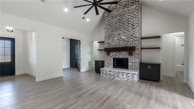 10017 Panther Creek Dr, Iola, TX 77861 - unfurnished living room featuring high vaulted ceiling, a ceiling fan, baseboards, light wood-style floors, and a brick fireplace