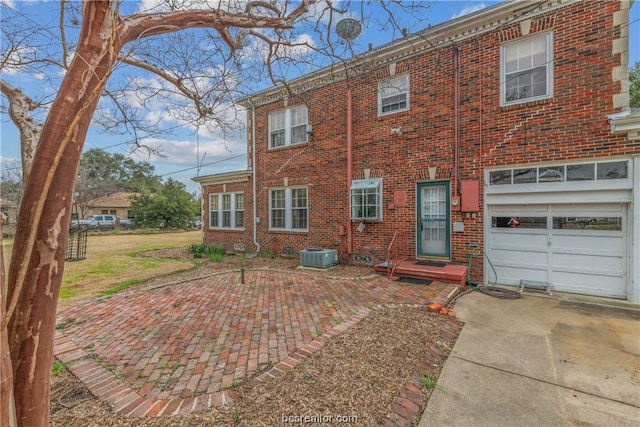 back of house featuring a garage