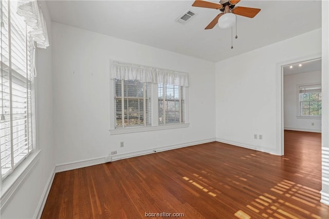 spare room featuring ceiling fan and dark hardwood / wood-style floors