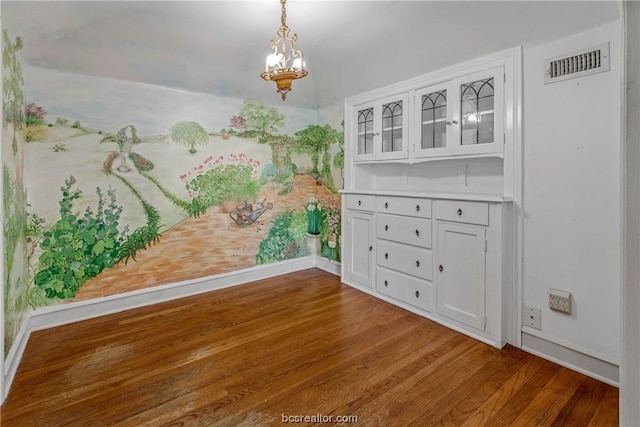 unfurnished dining area with dark hardwood / wood-style floors