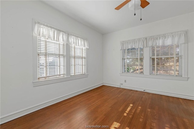 spare room with hardwood / wood-style floors and ceiling fan