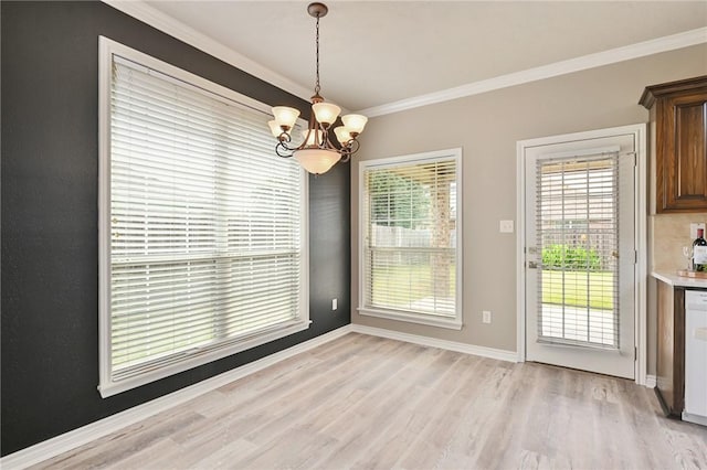 unfurnished dining area with light wood-style flooring, a chandelier, baseboards, and ornamental molding