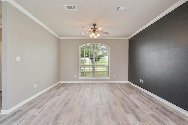 unfurnished room featuring crown molding, baseboards, visible vents, and light wood-style floors