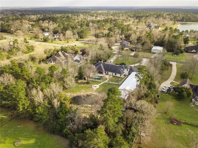 bird's eye view with a wooded view