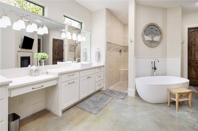 bathroom featuring a freestanding tub, a walk in shower, wainscoting, concrete flooring, and vanity