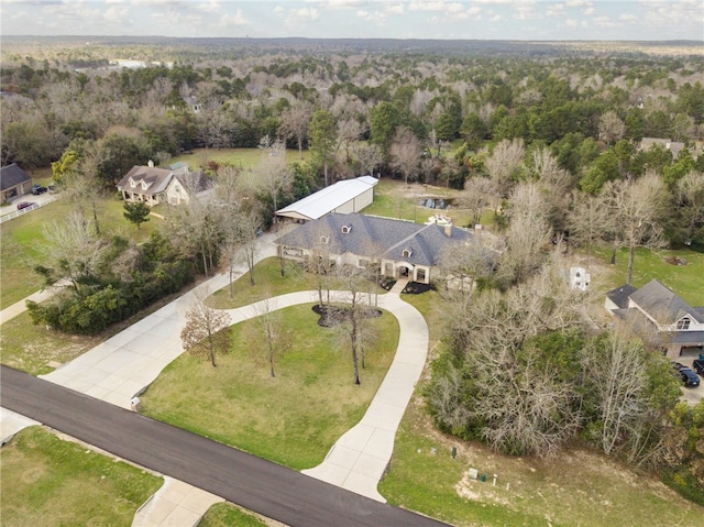 bird's eye view with a wooded view