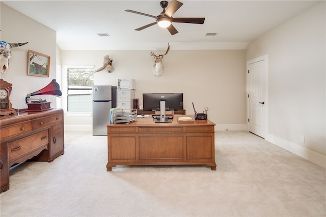 office featuring visible vents, light carpet, baseboards, ceiling fan, and vaulted ceiling