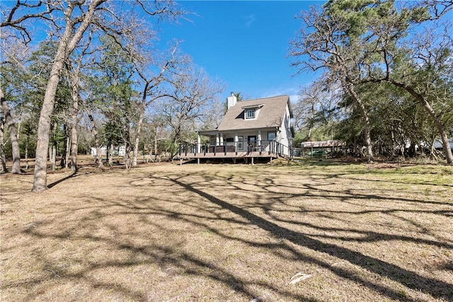 exterior space featuring a chimney and a deck