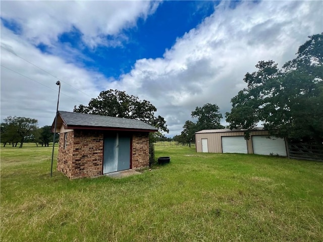 view of outbuilding with a garage and a lawn