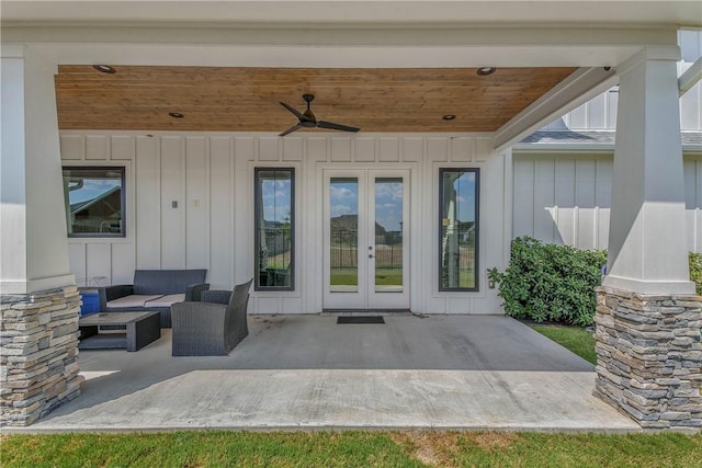 entrance to property with french doors, an outdoor living space, ceiling fan, and a patio area