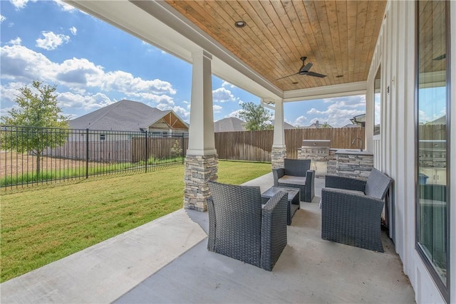 view of patio featuring an outdoor kitchen, ceiling fan, and grilling area