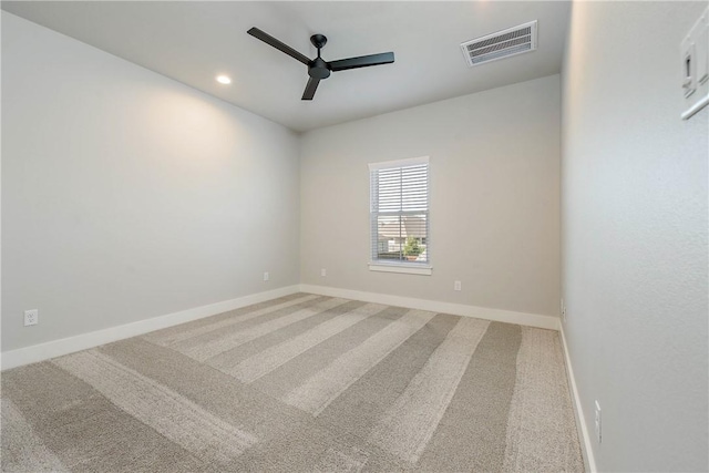 spare room featuring carpet floors and ceiling fan