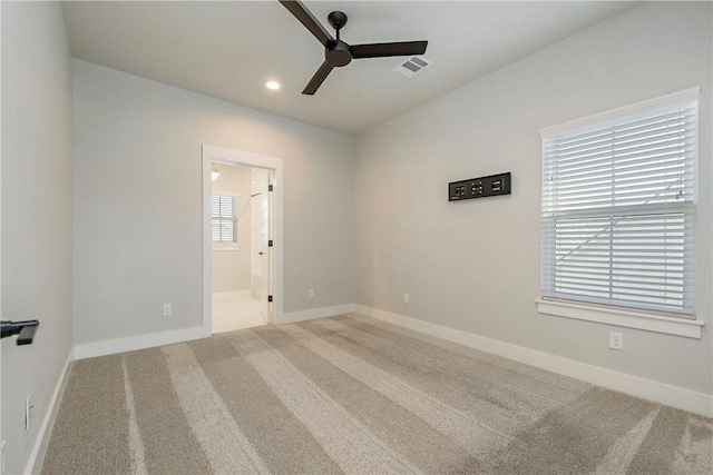 carpeted spare room with ceiling fan