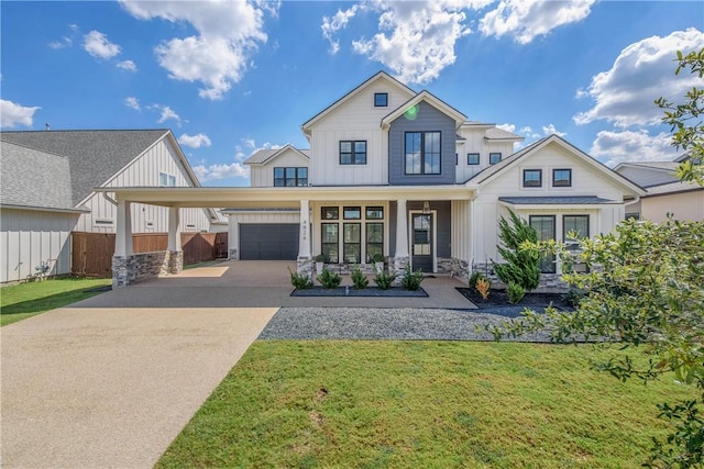 view of front of property with a front yard, a porch, and a garage