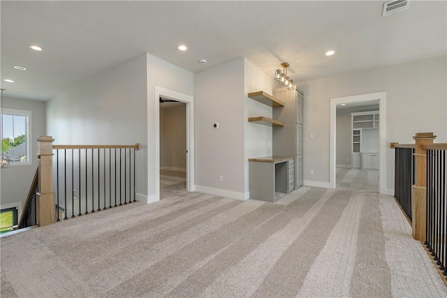 unfurnished living room featuring light colored carpet