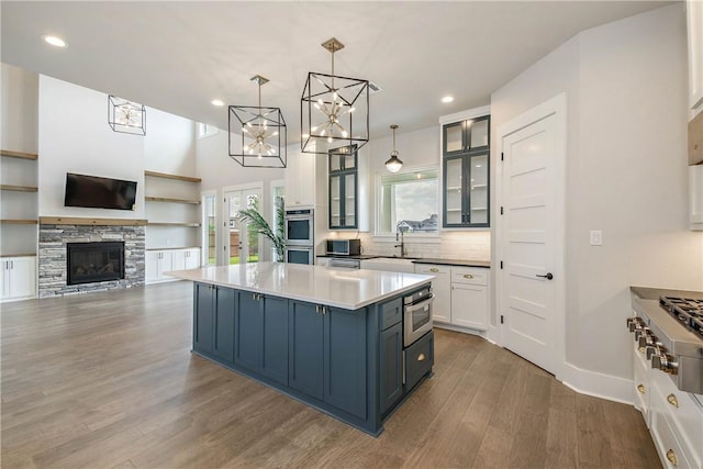 kitchen featuring plenty of natural light, hanging light fixtures, and a kitchen island