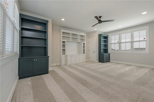 unfurnished living room with ceiling fan and light carpet