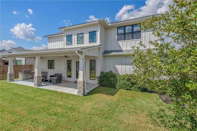 back of house with a lawn, a patio area, ceiling fan, and exterior kitchen