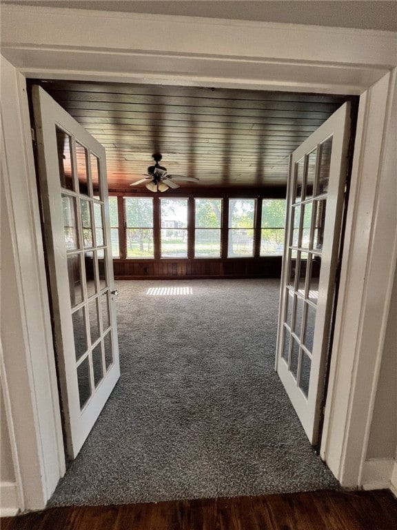 unfurnished sunroom featuring french doors and carpet flooring