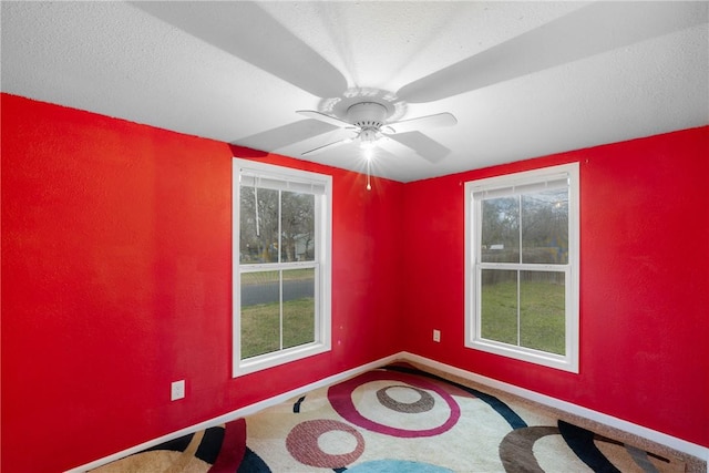 carpeted empty room with ceiling fan