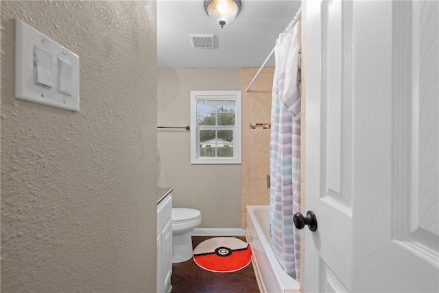 full bathroom with vanity, hardwood / wood-style floors, shower / bath combination with curtain, and toilet