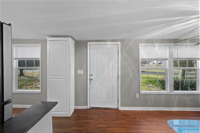 entrance foyer featuring dark wood-type flooring and a textured ceiling