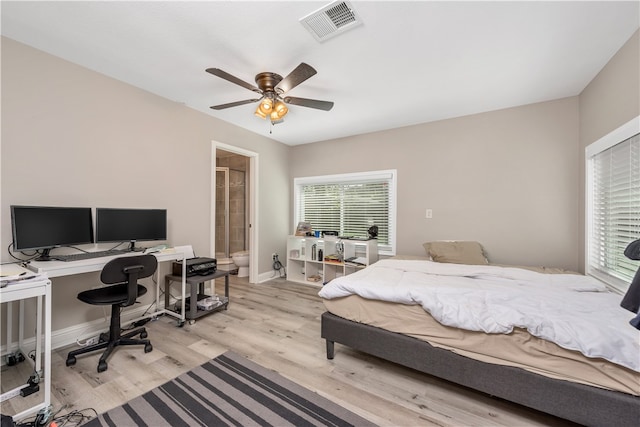 bedroom with baseboards, ensuite bath, light wood-style flooring, visible vents, and ceiling fan