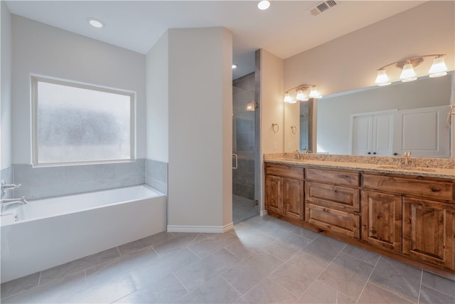 bathroom with tile patterned floors, vanity, and independent shower and bath