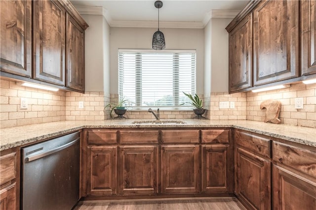 kitchen with dishwasher, decorative light fixtures, crown molding, and sink